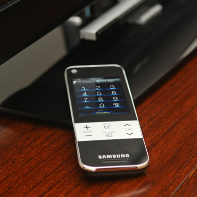 SAMSUNG® Touch Remote Control - This 3” color, touch-sensitive screen remote that interacts like a smartphone allows you to find your favorite programs quickly and easily! Sync up your entire household with AllShare™ which lets you remotely browse media files on a PC and play them on your TV. It also features a QWERTY keyboard making navigation easy. There is no need to worry about batteries; the remote control can be recharged via the included power cable.